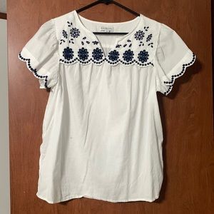 White blouse with navy blue embroidery